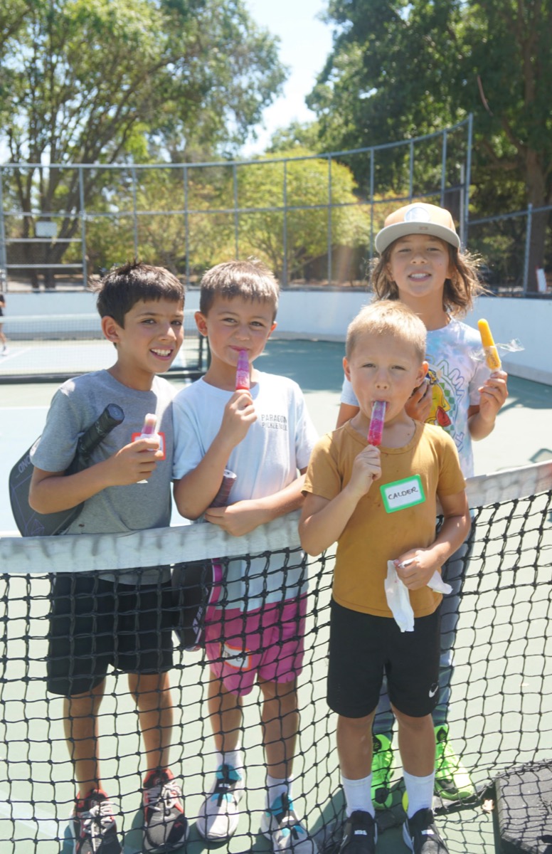 Campers cooling off with popsicles courtside